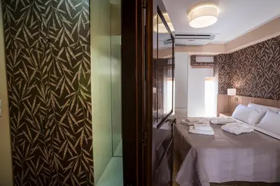 a bedroom with a bed with two towels on it at Horizon Deluxe House in Chania Town
