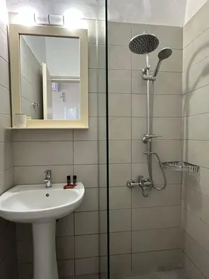 a bathroom with a sink and a shower with a mirror at Electra Studios in Gerani Chanion