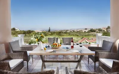 a table with a bowl of fruit on a patio at Villa Vanelia Mare in Kalamaki Chanion