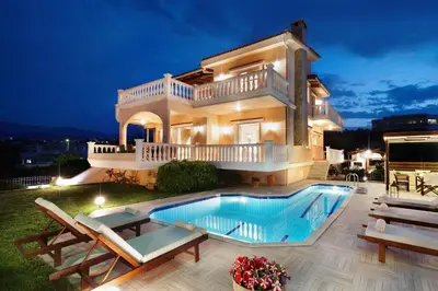 a villa with a swimming pool at night at Villa Vanelia Mare in Kalamaki Chanion