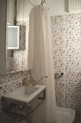 a bathroom with a sink and a shower at Christini Apartment in Chania Town