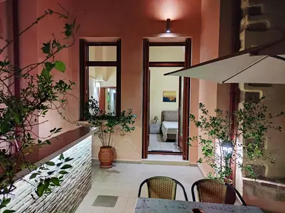a restaurant with a table and chairs and a mirror at Odyssey Studios in Chania Town