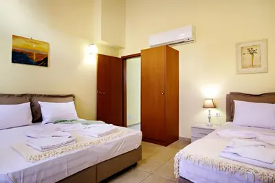 a bedroom with two beds with towels on them at Odyssey Studios in Chania Town
