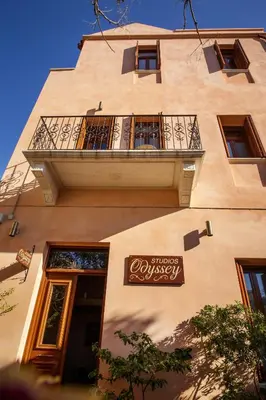 a building with a sign on the side of it at Odyssey Studios in Chania Town