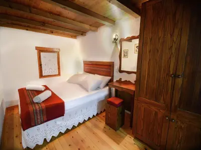 a bedroom with a bed and a wooden cabinet at Villa in Crete with Vineyard Experience in Kalamítsion Alexándrou