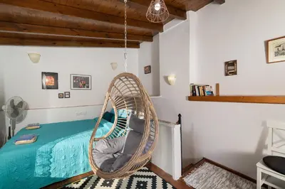 a room with a rattan swing in a room at Hera Studios in Chania Town