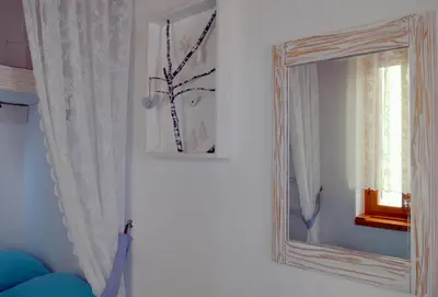 a mirror sitting on a wall next to a window at Hera Studios in Chania Town