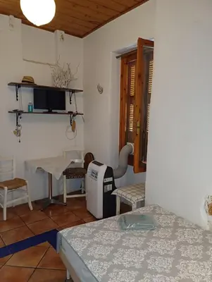 a room with a table and a table and chairs at Hera Studios in Chania Town