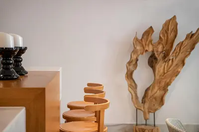 a wooden spiral staircase next to a wall with a tree sculpture at Avra City Boutique Hotel in Chania Town