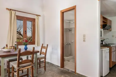 a kitchen and dining room with a table and chairs at Androulakis Apartments in Gerani Chanion