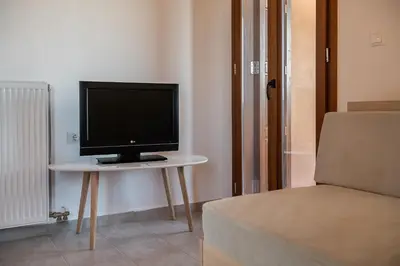 a television sitting on a table in a room at Androulakis Apartments in Gerani Chanion