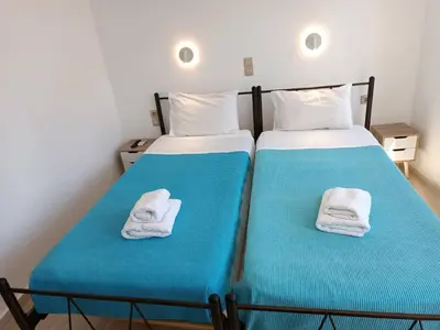 two beds with towels on them in a room at Imeros in Chania Town