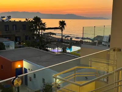 a view of the beach from the balcony of a building at Τhe Noverian Antama Organic Beach Resort Chania with Outdoor Heated Pool in Agia Marina Nea Kydonias