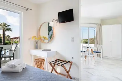 a bedroom with a bed and a mirror and a table at Villa Life in Agia Marina Nea Kydonias