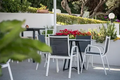 a table and chairs on a patio with flowers at Villa Life in Agia Marina Nea Kydonias