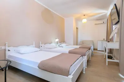 a hospital room with three beds and a sink at Archontiki City Hotel in Chania Town