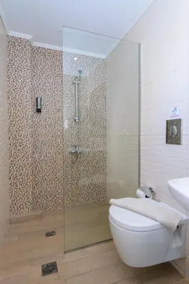 a bathroom with a shower and a toilet and a sink at Archontiki City Hotel in Chania Town