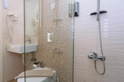 a bathroom with a shower with a toilet and a sink at Archontiki City Hotel in Chania Town