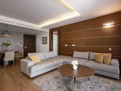 a living room with a couch and a table at Minoa Palace Resort in Plataniás