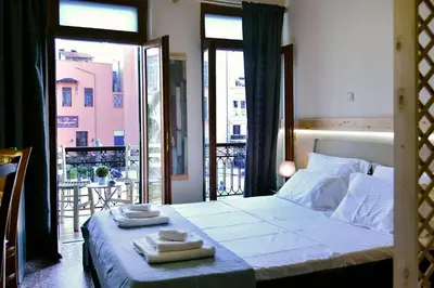 a bedroom with a bed with two towels on it at Nikolas Rooms in Chania Town