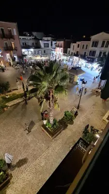 a palm tree in the middle of a street at night at Nikolas Rooms in Chania Town