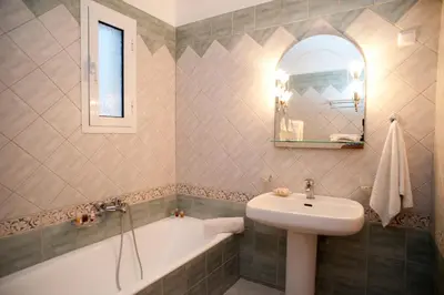 a bathroom with a sink and a bath tub at Villa Alexander in Kalathas