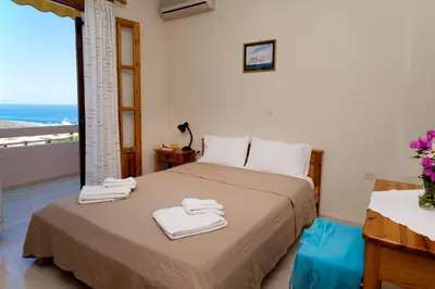a bedroom with a bed with towels on it at Villa Alexander in Kalathas