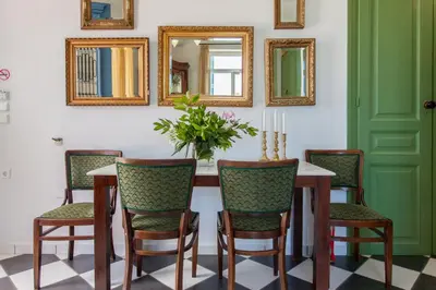 a dining room with a table with chairs and mirrors at Metohi Georgila in Maleme