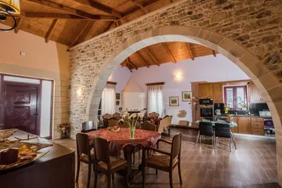 a kitchen and a living room with a table and chairs at PRIVATE Sapphiros Villa in Kissamos