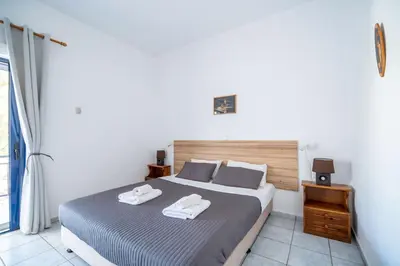 a bedroom with a bed with two towels on it at Maria's Studios in Frangokastello