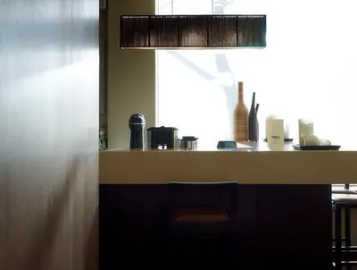 a kitchen with a counter with a chair in it at Irida Hotel in Chania Town
