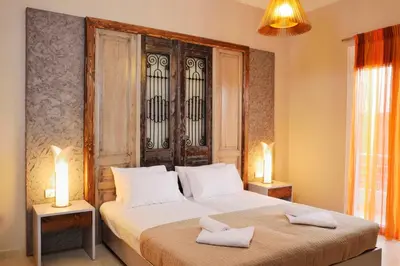a bedroom with a bed and two lamps on tables at Elia Kounoupidiana Apartment in Kounoupidhianá