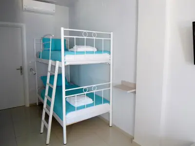 a room with a bunk bed with a ladder at Petrakis sunset in Palaiochóra