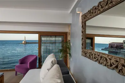 a living room with a couch and a mirror at Residenza Vranas Boutique Hotel in Chania Town