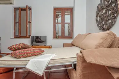 a living room with a couch and a coffee table at Casa Sabbionara in Chania Town