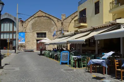 an empty street with tables and chairs in front of a building at Casa Sabbionara in Chania Town