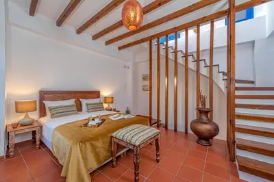 a bedroom with a bed and a staircase at Casa Sabbionara in Chania Town