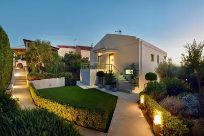 a house with a garden with a lawn at Sunlight Breeze Villa in Chania Town
