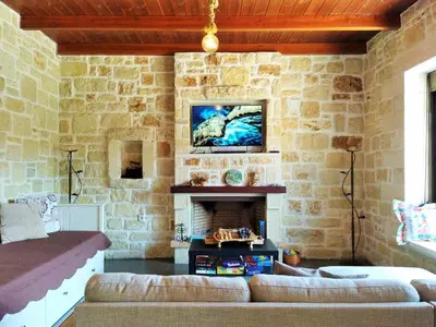a living room with a couch and a fireplace at Little House on the Prairie - Chania in Katokhórion