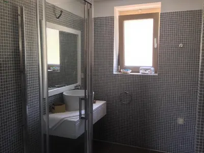 a bathroom with a sink and a toilet and a window at Anny's Homes in Kountoura Selino