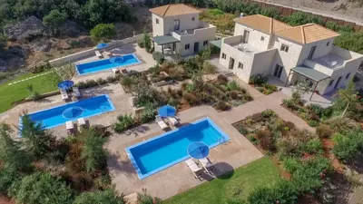 an aerial view of a house with two swimming pools at Anny's Homes in Kountoura Selino