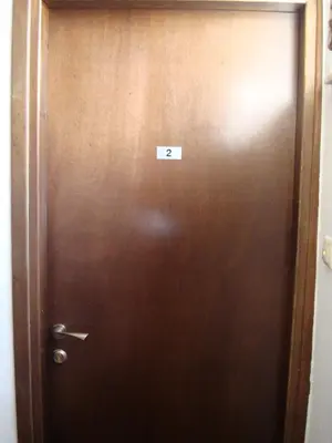 a brown door with a sign on it at Old Town Apartments in Chania Town