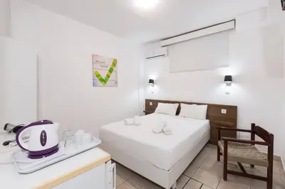 a bedroom with a bed and a table with a blender at Kissamia - Self Check In Only - Next to Night Clubs in Kissamos