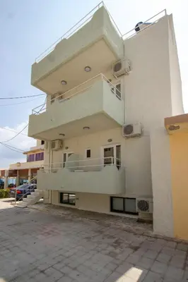 a building with a balcony on the side of it at Kissamia - Self Check In Only - Next to Night Clubs in Kissamos