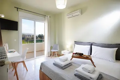 a bedroom with a bed with towels on it at Dream Villa in Kambánion