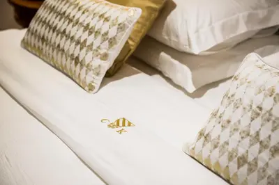 a white bed with two pillows on top of it at Casa Kallergi in Chania Town
