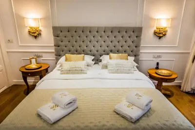 a bedroom with a large bed with towels on it at Casa Kallergi in Chania Town