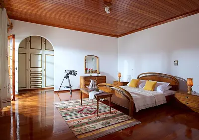 a bedroom with a bed and a mirror and a camera at Villa Mare in Tersanas