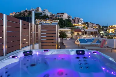 a bath tub sitting on top of a balcony at Angels Suites in Plataniás