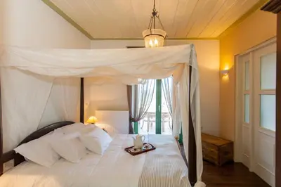 a bedroom with a white bed with a tray on it at Augusta Country House in Derés